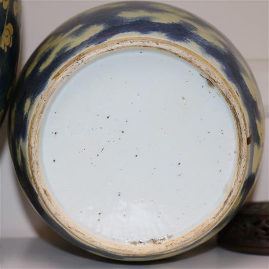 Two Chinese blue and white ovoid jars, 19th century, largest 23cm, carved wood stands and cover